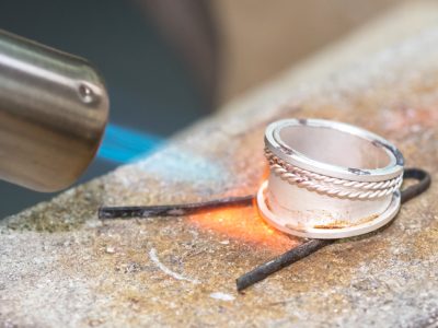 Tutor demonstrating soldering a byzantine ring