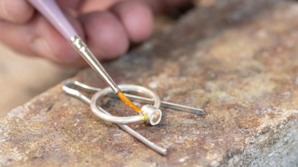 Solder being placed on ring and setting