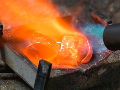 Gold jewellery being melted with a torch