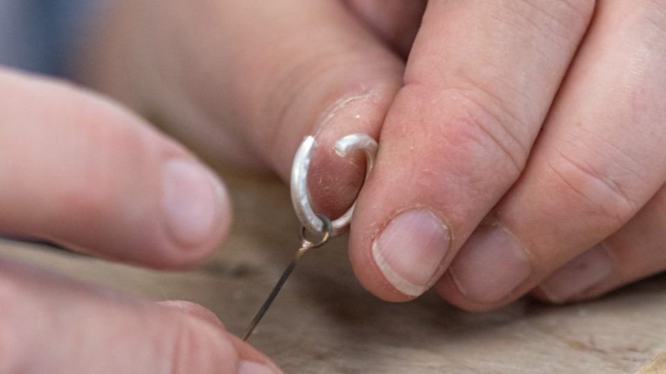 Threading the earring hook onto the silver hoop