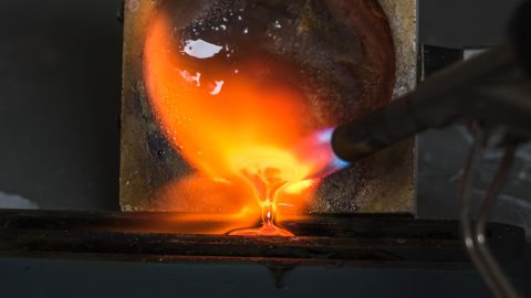 Silver being melted down using a torch